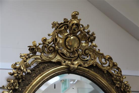 A large Victorian oval gilt wall mirror, 4ft 7in.